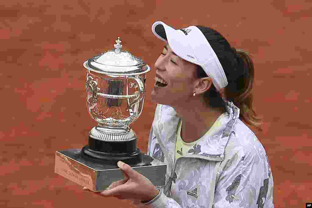 Garbine Muguruza dari Spanyol memegang piala setelah memenangkan final Perancis Terbuka dari petenis AS Serena Williams di Stadion Rolland Garos, Paris (4/6).&nbsp;(AP/David Vincent)