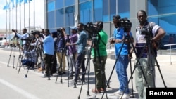 FILE - Reporters are seen during a stake-out in Mogadishu, Somalia, Dec. 29, 2019. The Somali government recently directed journalists to replace the name used for the Islamist extremist group "al-Shabab" with "khawarij," which means "a deviation from Islam."