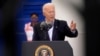 In an image taken through scaffolding, President Joe Biden speaks during a trip to Housten, Texas, Feb. 26, 2021. 
