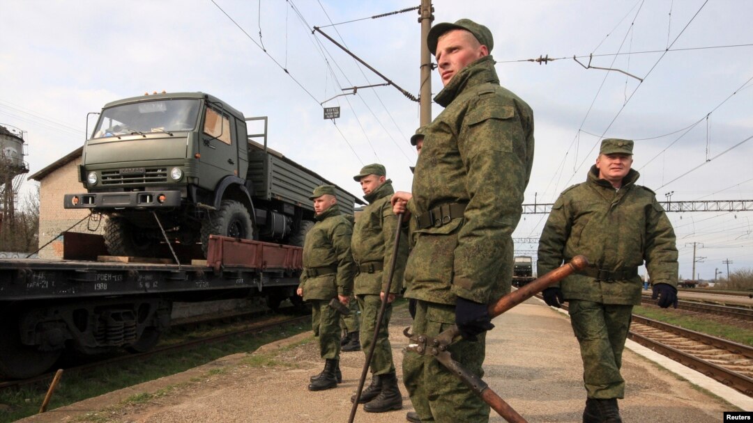 Russian servicemen stand in front of a military truck on a freight carriage near the Crimean city of Simferopol April 1, 2014. NATO says it will explore all options to boost the alliance's defenses after seeing no signs of a Russian troop withdrawal.