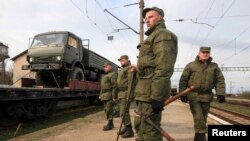 Russian servicemen stand in front of a military truck on a freight carriage near the Crimean city of Simferopol April 1, 2014. NATO says it will explore all options to boost the alliance's defenses after seeing no signs of a Russian troop withdrawal.