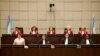 Judges, back row, from left, Janet Nosworthy, Micheline Braidi, Robert Roth, David Re and Walid Akoum of the UN-backed Special Tribunal for Lebanon(STL) are seen at the opening of a public hearing at the court in Leidschendam, near The Hague,…