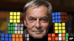 Erno Rubik, the inventor of the Rubik's Cube, poses at Liberty Science Center in Jersey City, N.J., April 25, 2012, 
