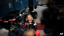 European Union Foreign Policy chief Federica Mogherini talks to journalists as she arrives to an European Foreign Affairs Ministers meeting at the Europa building in Brussels, Nov. 11, 2019.