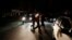 FILE - People walk on a street during a blackout in Caracas, Venezuela, Dec. 2, 2013.