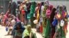 Internally displaced Somali women stand in a queue waiting for relief food to be served in Hodan district south of capital Mogadishu September 5, 2011. 