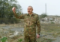FILE - This official photo from his office shows Azerbaijan's President Ilham Aliyev addressing reporters as he visits Fuzuli and Jabrayil districts in the region of Nagorno-Karabakh, Nov. 16, 2020.