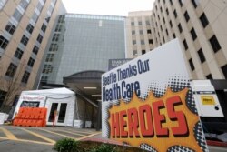 A sign posted in front of the emergency entrance of Harborview Medical Center gives thanks to health care workers during the coronavirus outbreak March 28, 2020, in Seattle, Washington.