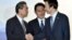 Japanese Foreign Minister Fumio Kishida, center, watches as Chinese Foreign Minister Wang Yi, left, shakes hands with South Korean Foreign Minister Yun Byung-se after the press conference following the trilateral meeting in Tokyo, Aug. 24, 2016.