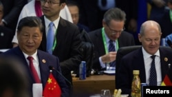 China's President Xi Jinping, left, and German Chancellor Olaf Scholz attend the G20 summit at the Museum of Modern Art in Rio de Janeiro, Brazil, Nov. 18, 2024. The two also met Tuesday on the sidelines of the G20 Summit in Rio de Janeiro.