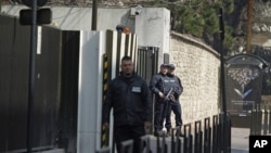 Armed police stand guard outside the French domestic intelligence agency headquarters (DCRI) in Levallois-Perret, near Paris, March 24, 2012. Abdelkader Merah and his girlfriend were transfered here from Toulouse for further questioning about the massacre