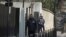 FILE - Armed police stand guard outside the French domestic intelligence agency headquarters (DCRI) in Levallois-Perret, near Paris, March 24, 2012. Abdelkader Merah and his girlfriend were transfered here from Toulouse for further questioning. 