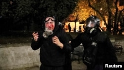 FILE - Police officers escort a demonstrator during a rally of opposition parties' supporters, who protest against the new government's decision to suspend the European Union accession talks and refuse budgetary grants until 2028, in Tbilisi, Georgia November 30, 2024.