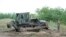 A bulldozer of the Hungarian Defense Force is used to prepare the terrain for the building of at the Hungarian-Serbian border near Morahalom, 179 kms southeast from Budapest, July 13, 2015. 