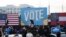Democratic candidates for Senate Jon Ossoff (L), Raphael Warnock (R) and US President-elect Joe Biden (C) wave from stage during a rally outside Center Parc Stadium in Atlanta, Georgia, on January 4, 2021. - President Donald Trump, still seeking ways to r