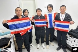 Thai hostages who were freed from Hamas, from left to right, Rumnao Surasak, Sathian Suwannakhan, Seathao Bannawat, Sriaoun Watchara and Thenna Pongsak, hold the Thail flag in Israel, Jan. 30, 2025.