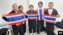 Thai hostages who were freed from Hamas, from left to right, Rumnao Surasak, Sathian Suwannakhan, Seathao Bannawat, Sriaoun Watchara, and Thenna Pongsak hold the Thailand flag in Israel, Jan. 30, 2025.