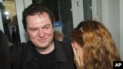 Andrzej Poczobut, a correspondent for one of Poland's major newspapers, Gazeta Wyborcza, with his wife Oksana in front of the court building where he was on trial in the town of Grodno, Belarus, July 5, 2011