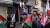 A Palestinian boy holds up a portrait of slain Hamas leader Yahya Sinwar during a rally in Ramallah in the occupied West Bank, Oct. 18, 2024.