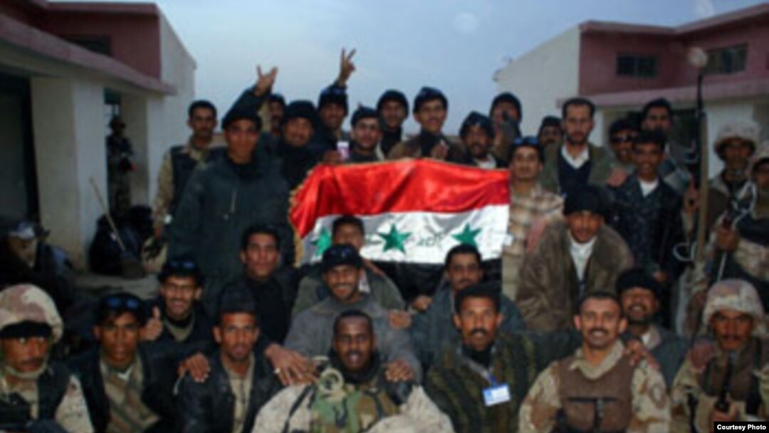 Abdullahi Mohamud, shown in front row at center, appears with Iraqi soldiers during peace-keeping efforts in Anbar province during the 2005 elections. 