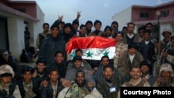 Abdullahi Mohamud, shown in front row at center, appears with Iraqi soldiers during peace-keeping efforts in Anbar province during the 2005 elections. 