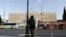 A woman stands opposite the Parliament in central Athens, Tuesday, Nov. 27, 2012. 
