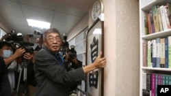 Lam Wing-kee, one of five shareholders and staff at the Causeway Bay Book shop in Hong Kong, hangs his congratulatory gift, Chinese calligraphy that reads: ''Freedom'' at his new book shop on the opening day in Taipei, Taiwan, Saturday, April 25,…