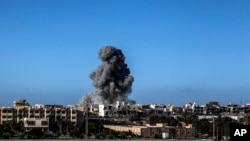 FILE - Smoke rises after an airstrike on an Islamic State target in Sirte, Libya, Sept. 28, 2016. A suspected Islamic State militant from Sirte reportedly was killed in a U.S. airstrike in the northwestern town of Bani Walid on Tuesday.