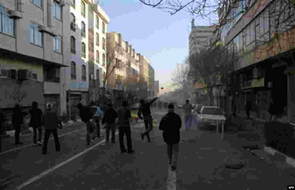 This photo, taken by an individual not employed by the Associated Press and obtained by the AP outside Iran shows Iranian protestors throwing stones at ant-riot police officers, during an anti-government protest in Tehran, Iran, Monday, Feb. 14, 2011. Eye