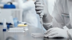 A researcher works in a lab run by Moderna Inc, in an undated still image from video.