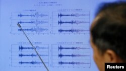 Japan Meteorological Agency's earthquake and tsunami observations division director Toshiyuki Matsumori points at graphs of ground motion waveform data observed in Japan during a news conference in Tokyo, Japan, September 3, 2017.