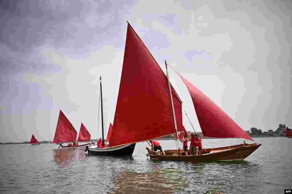Members of a cultural sailing association take part in the so-called &ldquo;Red Regatta&rdquo; in Venice, Northeastern Italy.