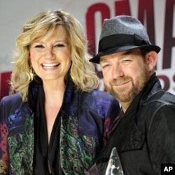 Jennifer Nettles, left, and Kristian Bush from the band Sugarland pose backstage with the award for vocal duo of the year at the 45th Annual CMA Awards in Nashville, Tenn., Nov. 9, 2011.