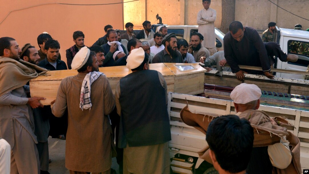 Afghan men carry the coffin of a victim of a deadly suicide attack in Kunar province, east of Kabul, Feb. 27, 2016. At least 10 civilians were killed when a suicide bomber on a motorcycle targeted on a local tribal leader near a park, an Afghan official said.