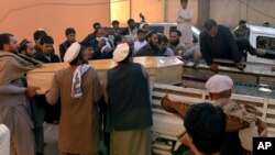 Afghan men carry the coffin of a victim of a deadly suicide attack in Kunar province, east of Kabul, Feb. 27, 2016. At least 10 civilians were killed when a suicide bomber on a motorcycle targeted on a local tribal leader near a park, an Afghan official said.