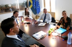 EU leaders meet on the sidelines of an EU summit at the European Council building in Brussels, July 19, 2020.