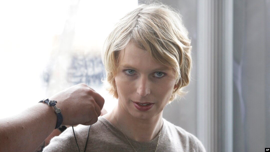 FILE - Chelsea Manning, right, is assisted with a microphone before an appearance at a forum, in Nantucket, Mass., Sept. 17, 2017.