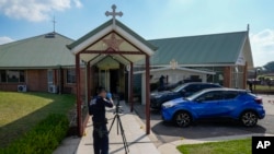 FILE - A police forensic officer works at a crime scene at the Christ the Good Shepherd church in suburban Wakely in western Sydney, Australia, April 16, 2024.