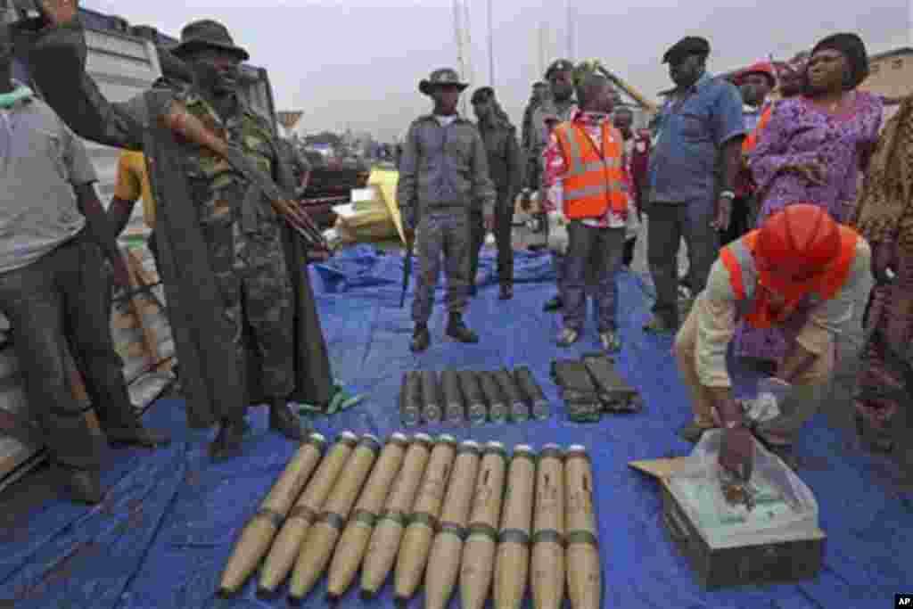 Wani soja yake nuna hanu a lokacinda suke nunawa manema labarai gungun makamai da jami'an tsaro suka kama a wata tashar jiragen ruwa ranar Talata da ta shige.