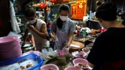 Adulwitch Tangsupmanee, 42, and Jirintat, son and daughter of Chanchai Tangsupmanee, who died at age 73 of the coronavirus disease (COVID-19) in July, prepare meals at their late father's food stall in Bangkok's Chinatown, Thailand, October 6, 2021. (REUTERS/Athit Perawongmetha)