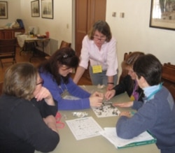 Lisa Purcell training parent volunteers to teach an elementary school workshop on owls.