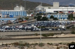 FILE - Cars sit at the General Motors plant in Ramos Arizpe, Mexico, Nov. 21, 2013.