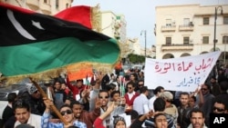 Men chant slogans during a protest in Benghazi, Libya, December 12, 2011.