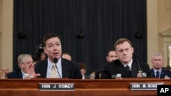 FBI Director James Comey, left, joined by National Security Agency Director Michael Rogers, right, testifies on Capitol Hill in Washington, March 20, 2017, before the House Intelligence Committee hearing on allegations of Russian interference in the 2016