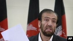 Afghan Election Commission Chairman Fazel Ahmad Manawi reads off names of the new parliamentarians during a press conference in Kabul, Afghanistan, August 21, 2011