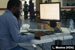 A technician analyzes poll results during a test of the Election Results Management System, at the main tallying center in Blantyre, Malawi.