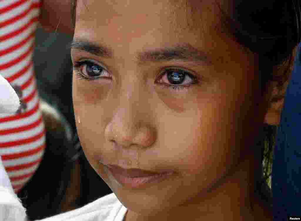 3주전 필리핀 마닐라 인근 나바타스에서 벌어진 마약사범 소탕전에서 사살된 용의자의 딸이 장례식에서 눈물을 흘리고 있다. &nbsp;