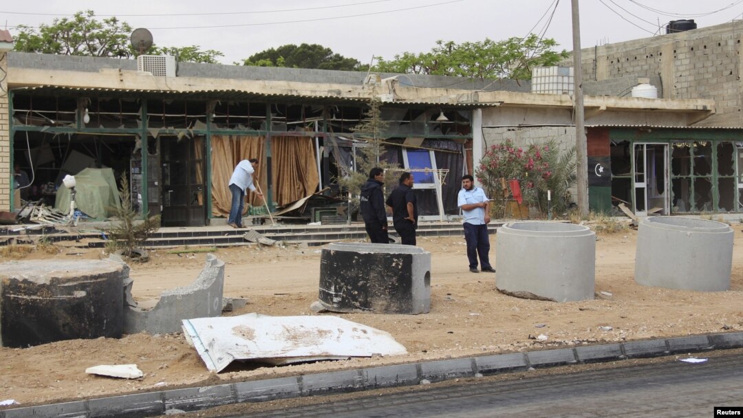 A man cleans his shop after a suicide car bomber blew himself up at a checkpoint in Dafniya outside Misrata, Libya, May 31, 2015.