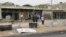 A man cleans his shop after a suicide car bomber blew himself up at a checkpoint in Dafniya outside Misrata, Libya, May 31, 2015.