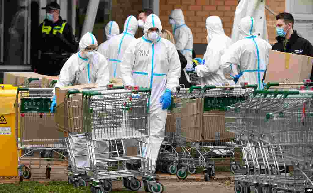 Members of the Melbourne Fire Brigade (MFB) prepare to take food parcels to residents in a locked down public housing estate in Melbourne, as the city re-enters a citywide lockdown after a fresh outbreak of the COVID-19 coronavirus.